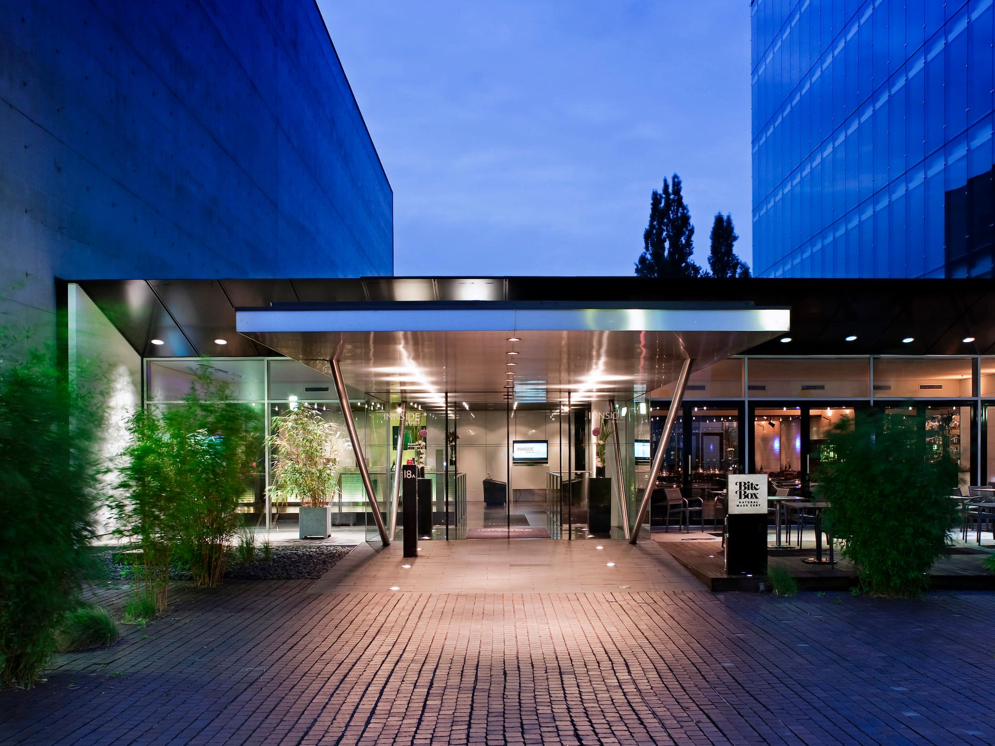 a building with glass doors and a brick walkway