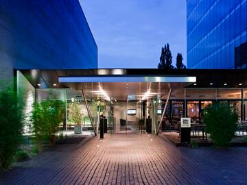 a building with glass doors and a brick walkway