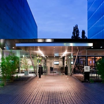 a building with glass doors and a brick walkway