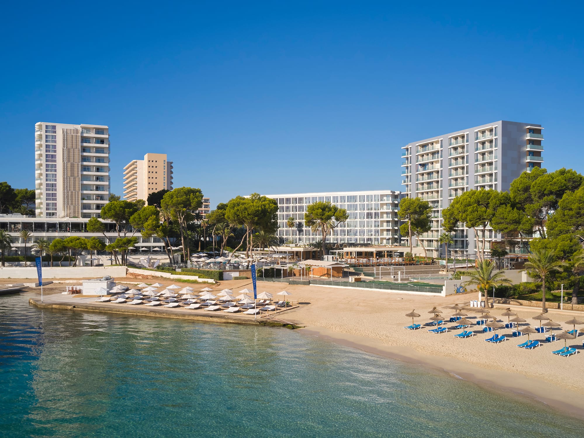 a beach with a body of water and buildings