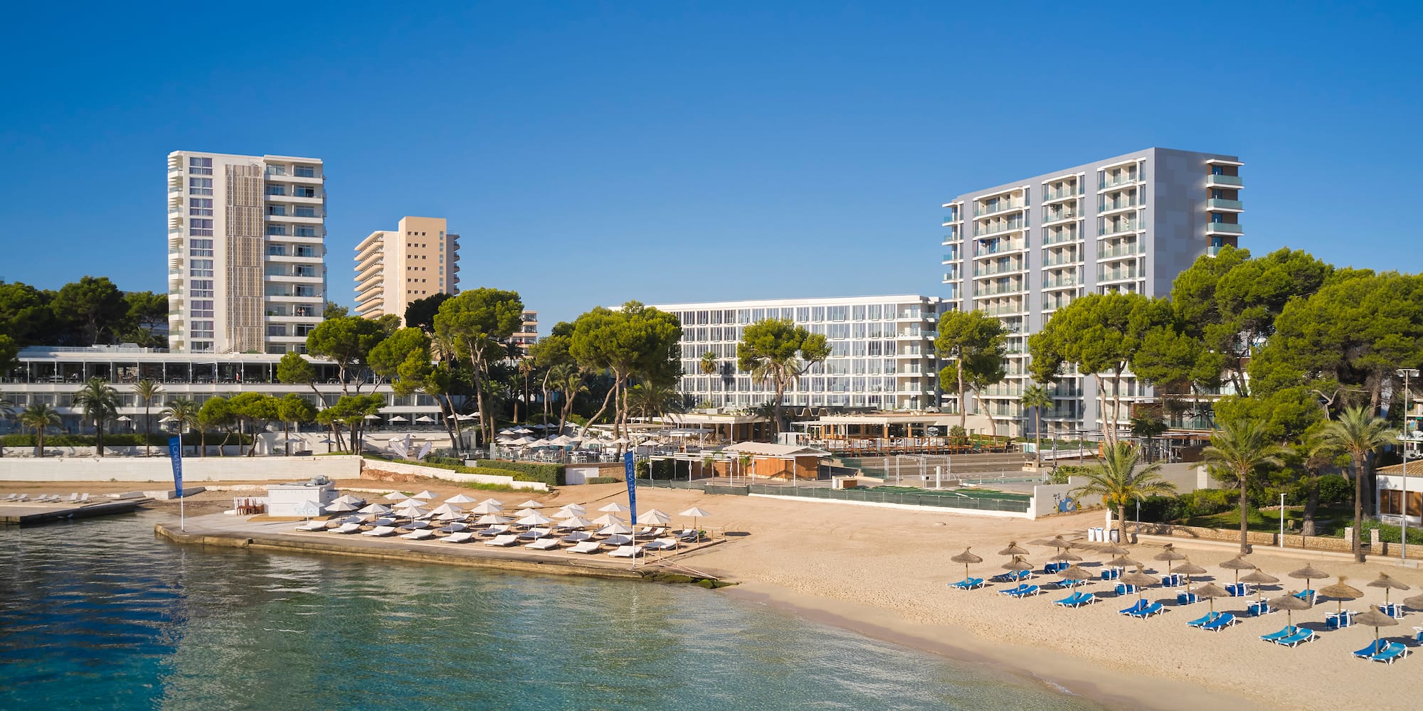 a beach with a body of water and buildings