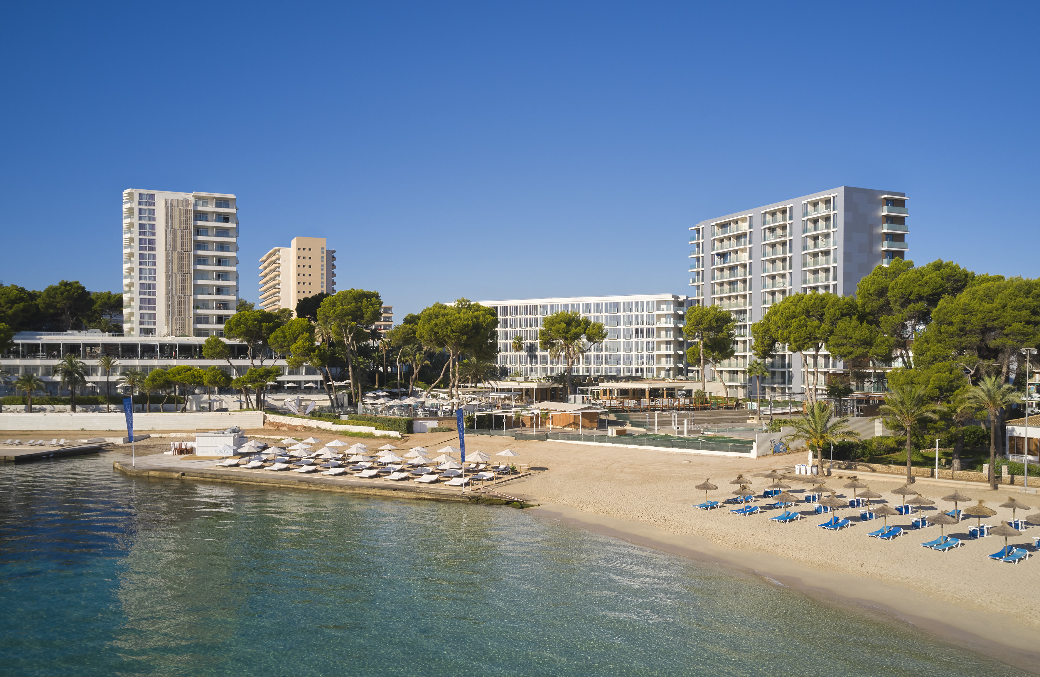 a beach with a body of water and buildings