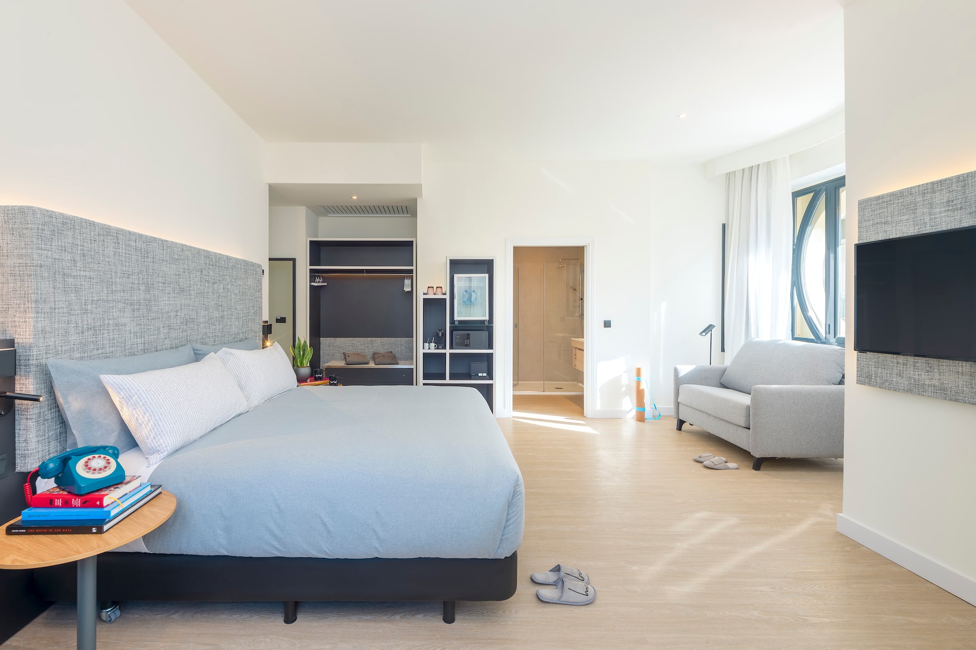 a bedroom with a bed and a couch