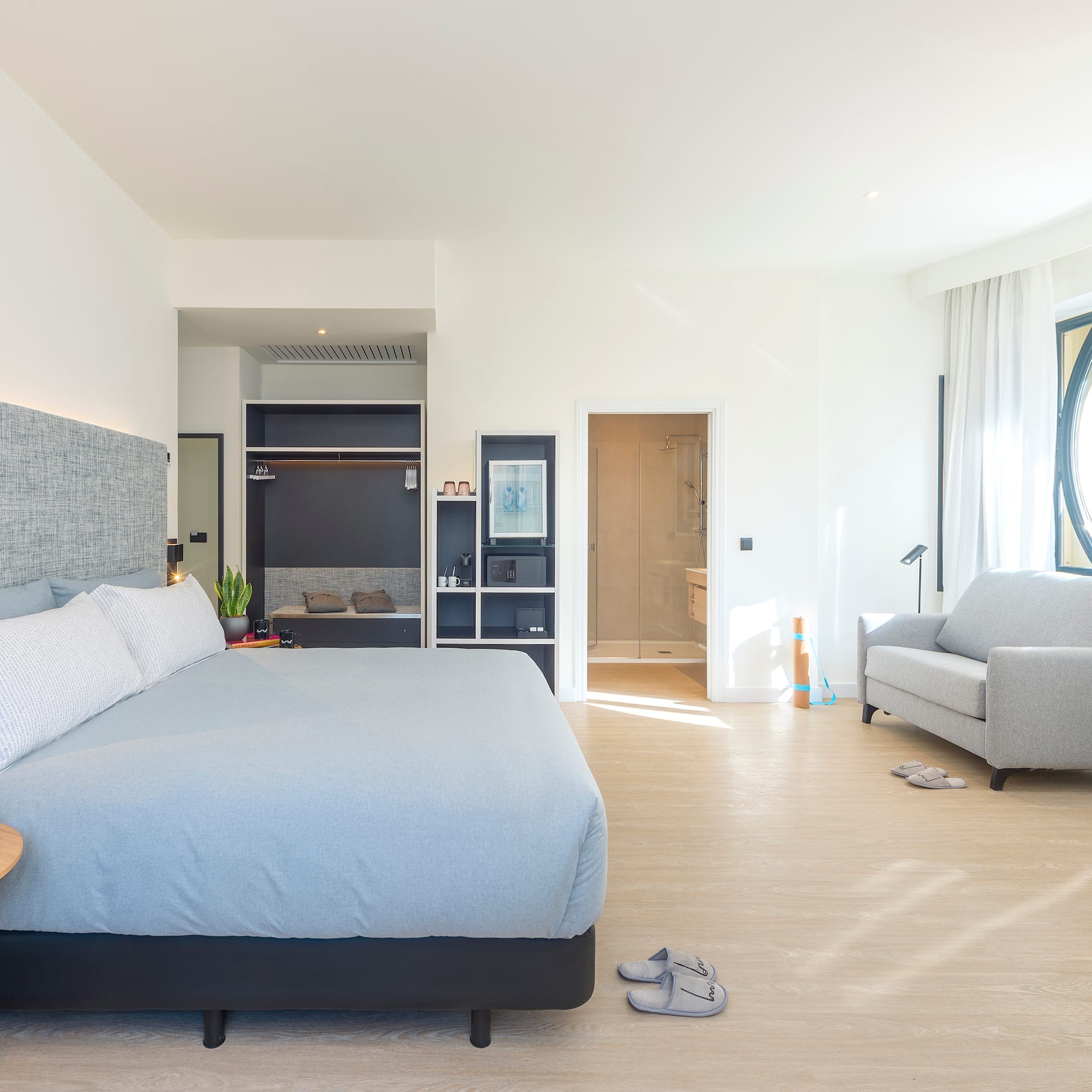 a bedroom with a bed and a couch