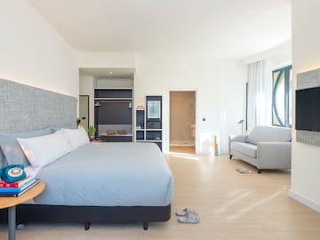 a bedroom with a bed and a couch