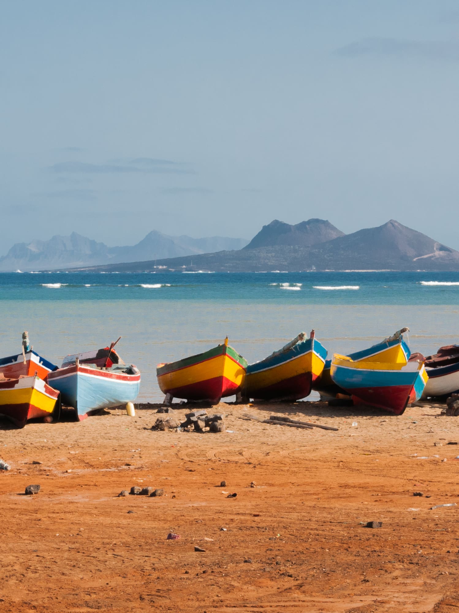 a group of boats on a beach