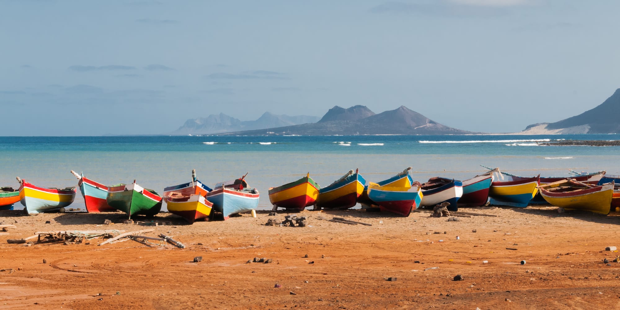 a group of boats on a beach