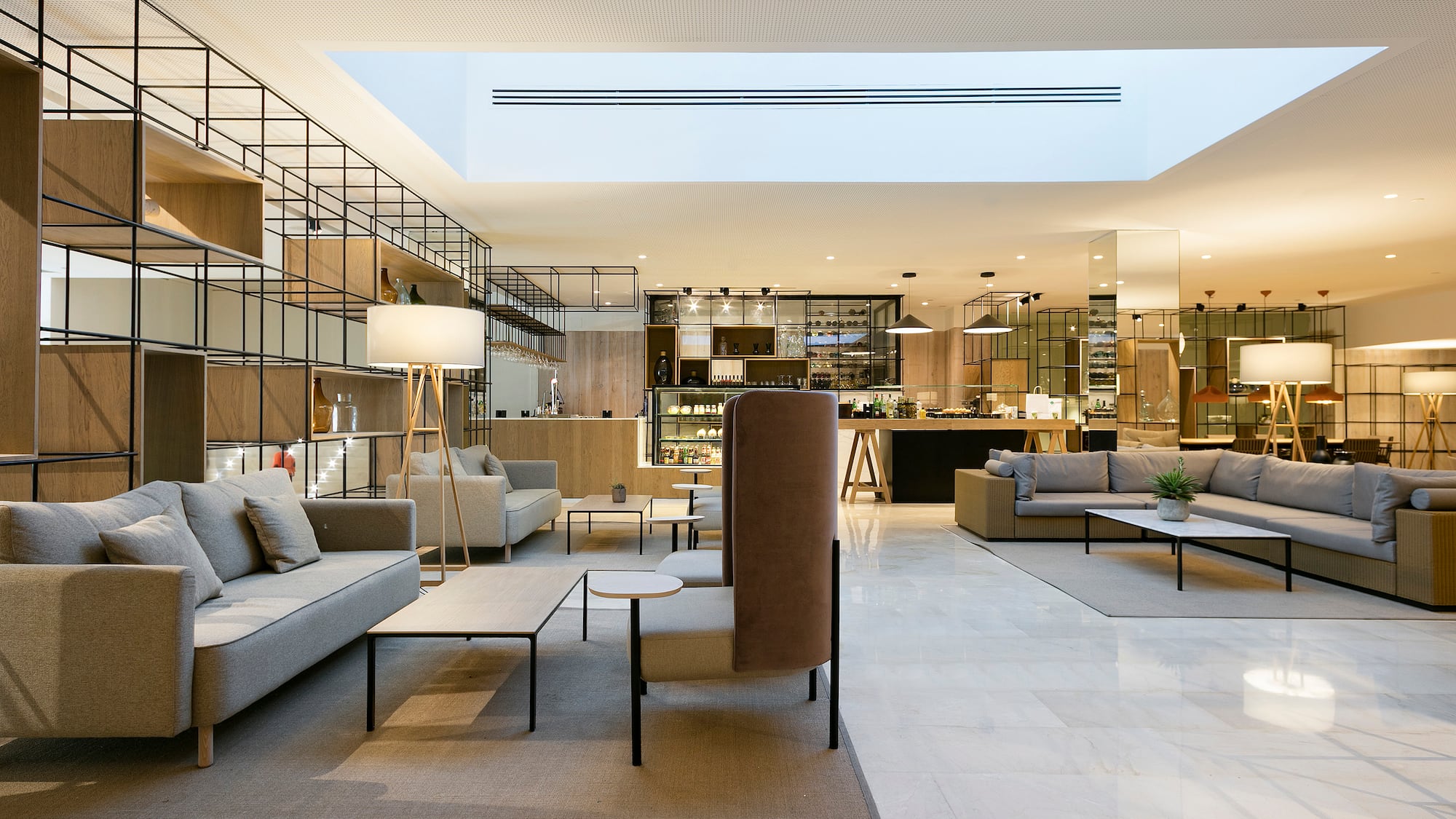 a room with a large couch and tables