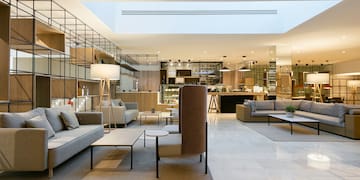 a room with a large couch and tables