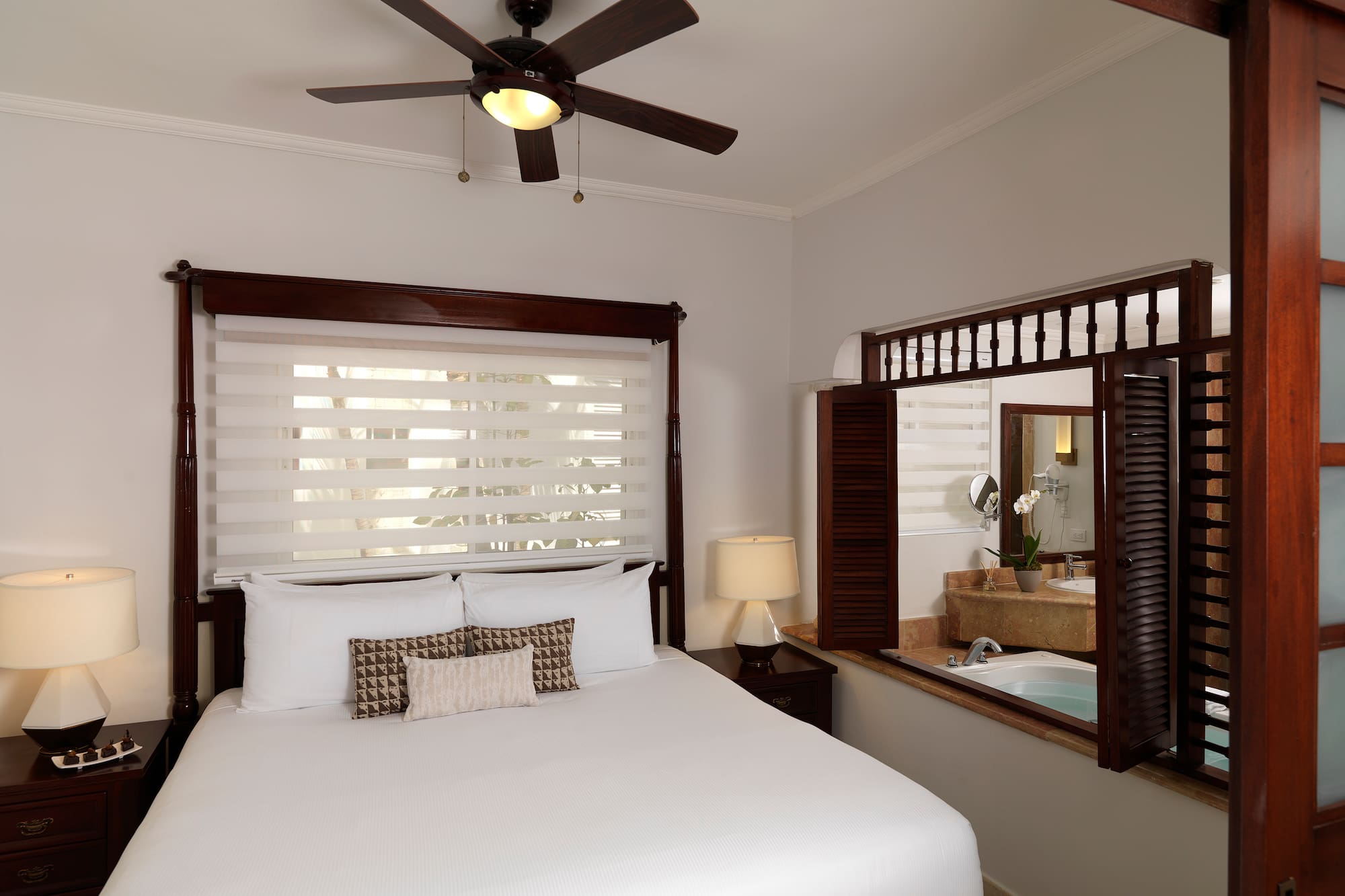 a bed with a fan and a window