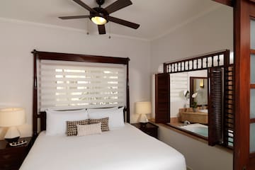 a bed with a fan and a window