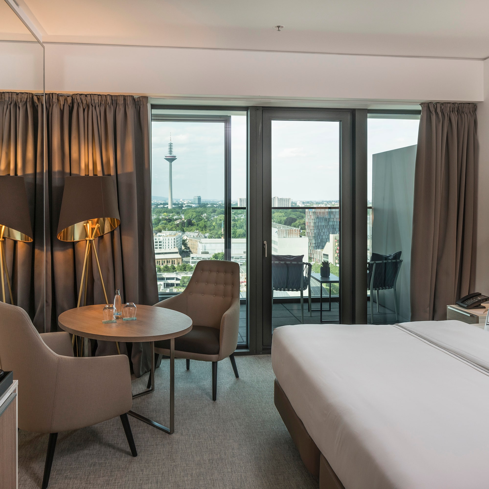 a room with a bed and chairs and a table