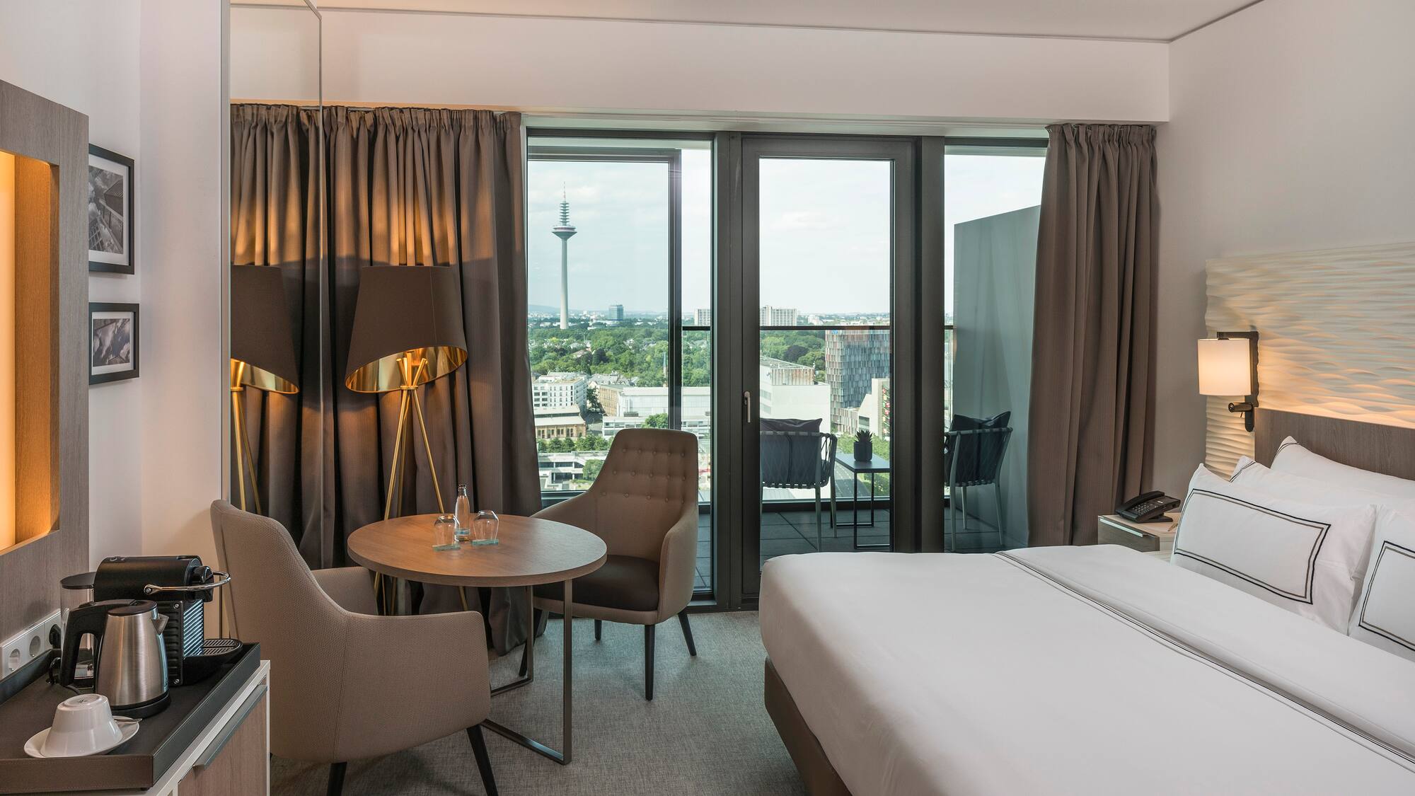 a room with a bed and chairs and a table