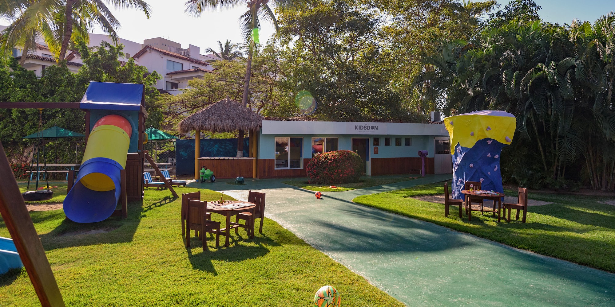 a playground with a table and chairs in the yard
