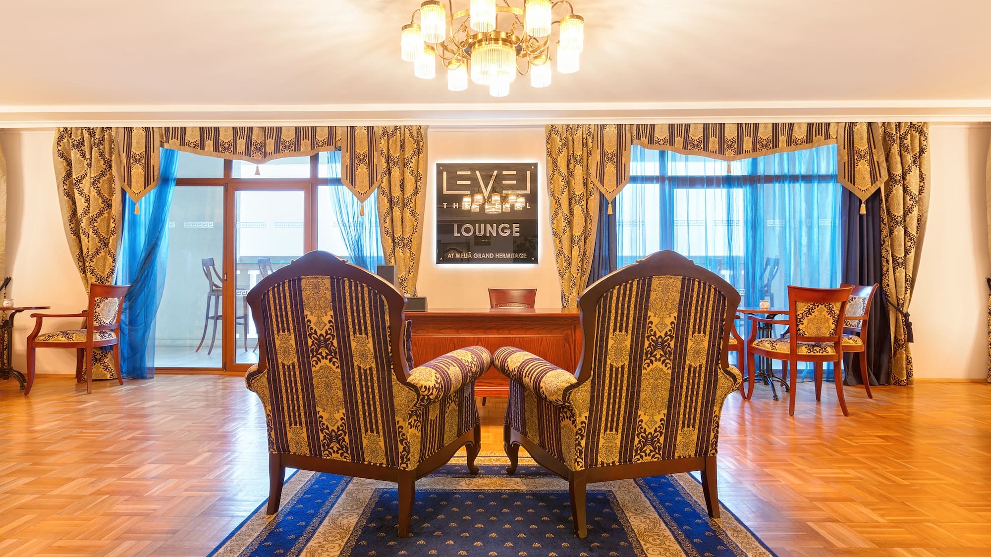 a room with chairs and a chandelier