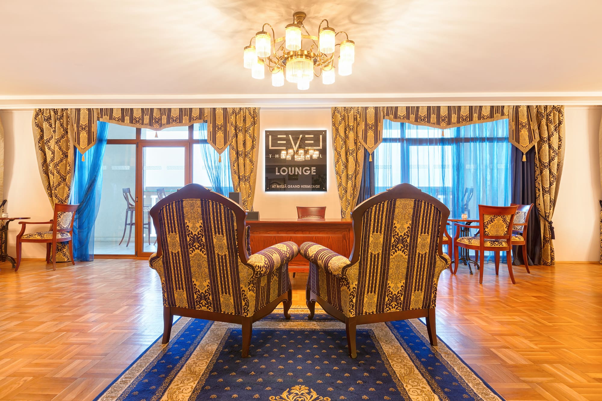 a room with chairs and a chandelier