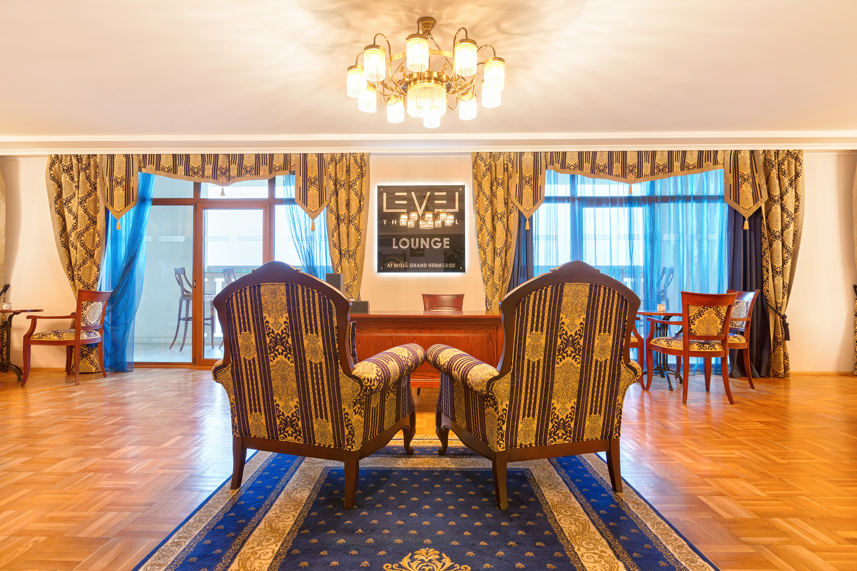 a room with chairs and a chandelier