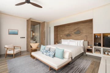 a room with a bed and a fan