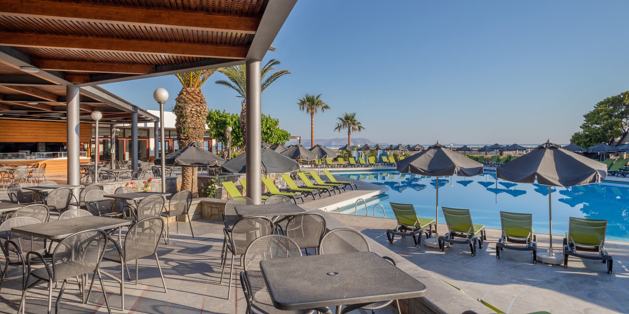 a pool with chairs and tables