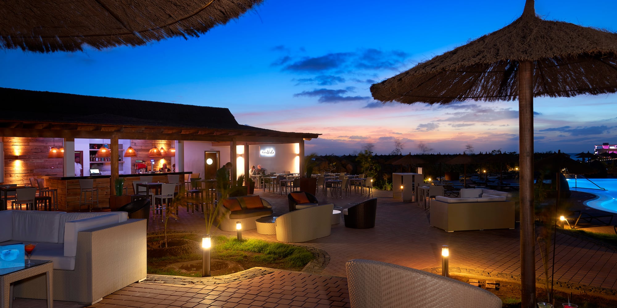 a patio with chairs and umbrellas
