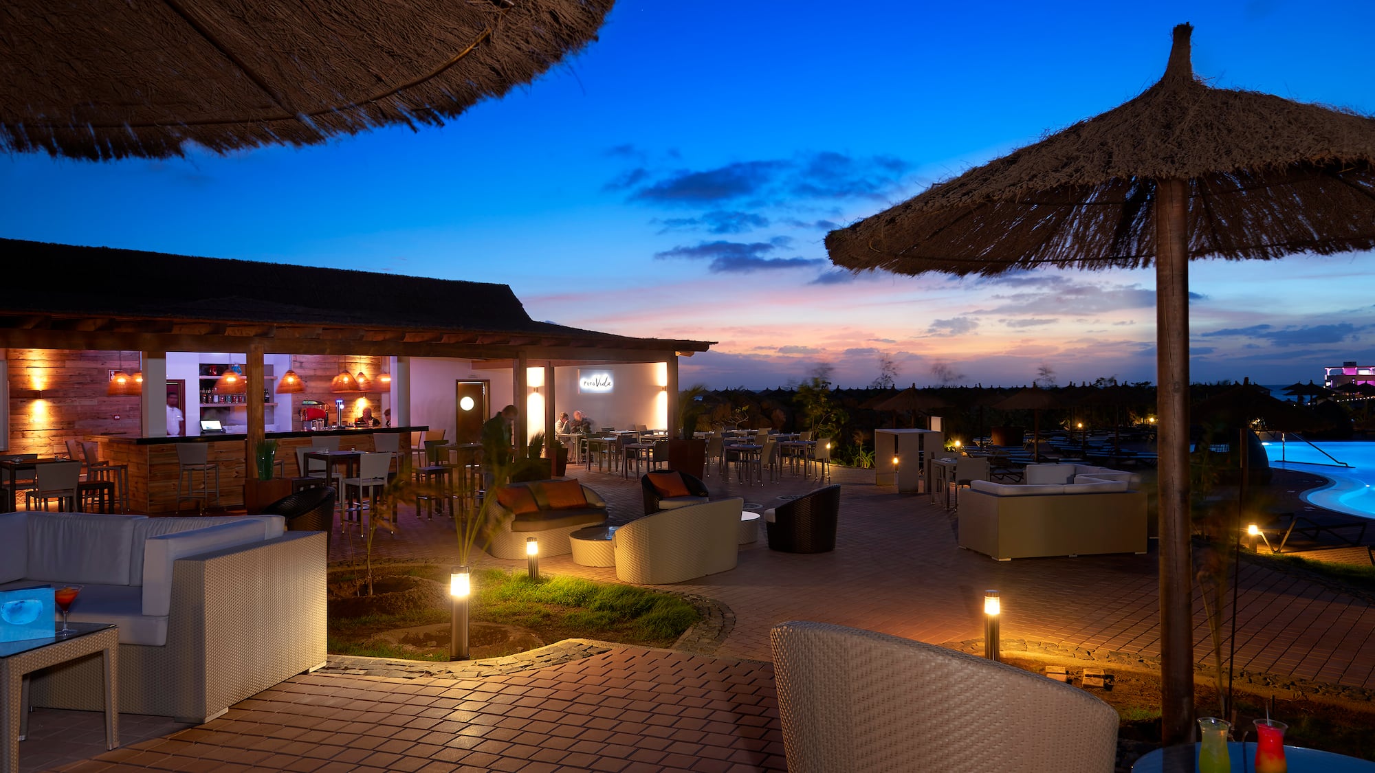 a patio with chairs and umbrellas