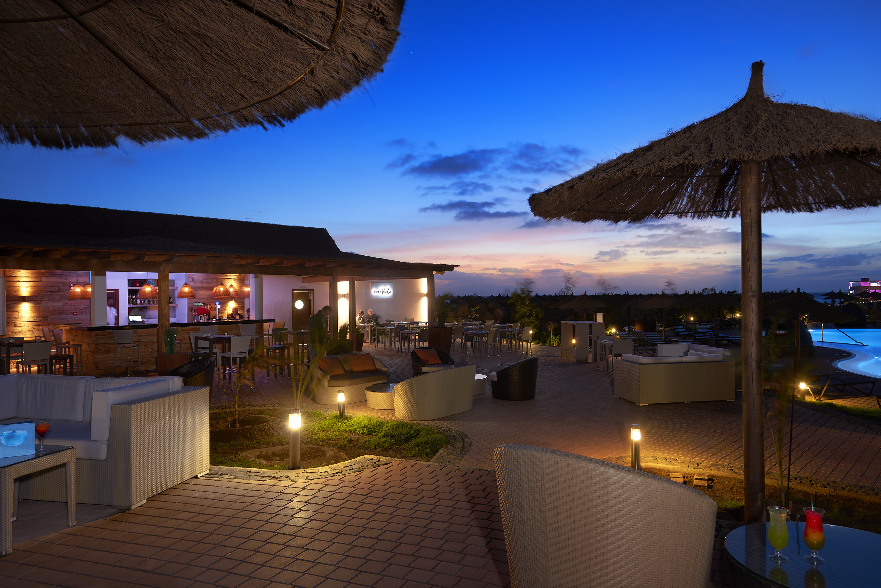 a patio with chairs and umbrellas