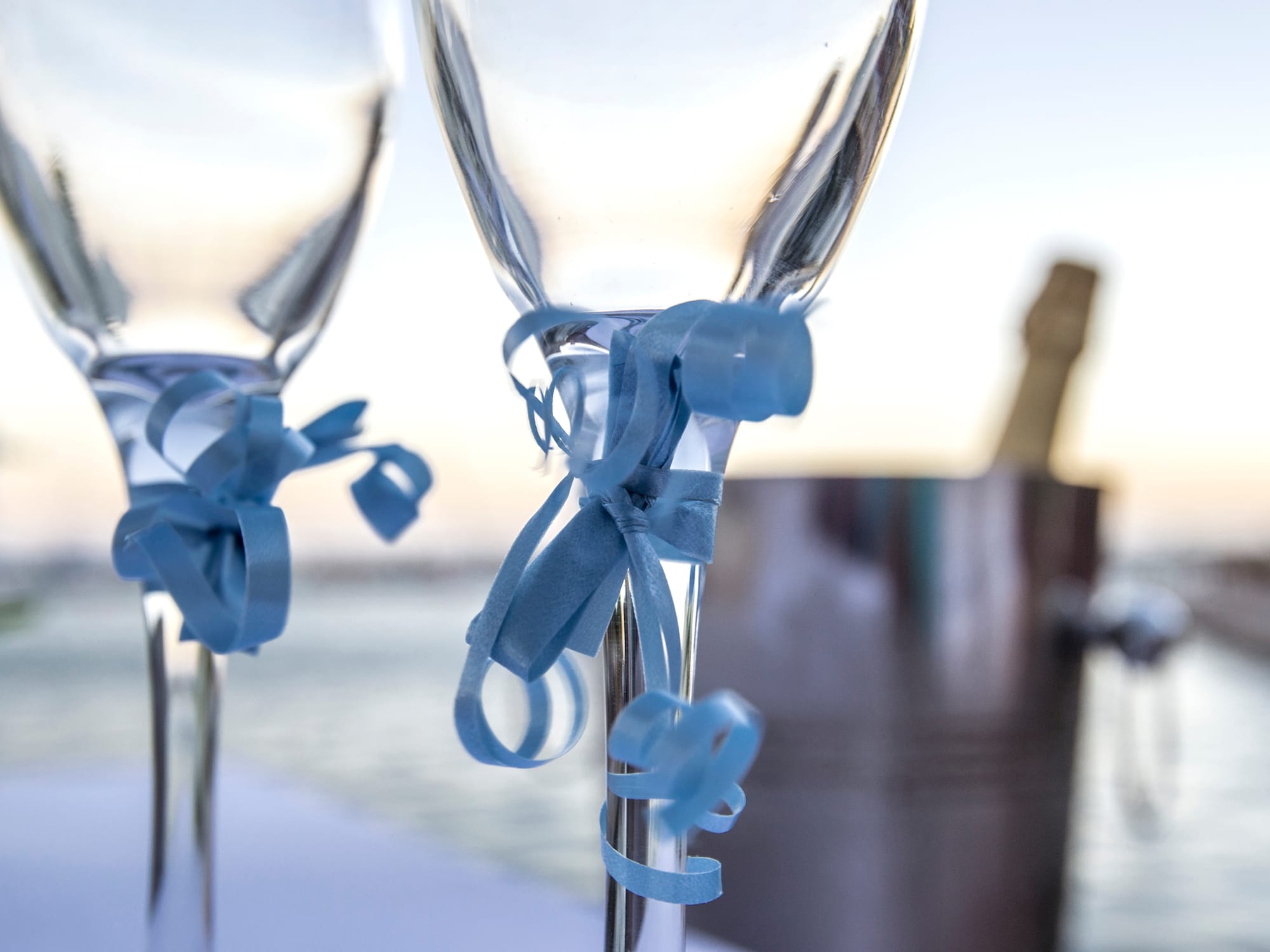 two glasses with blue ribbons