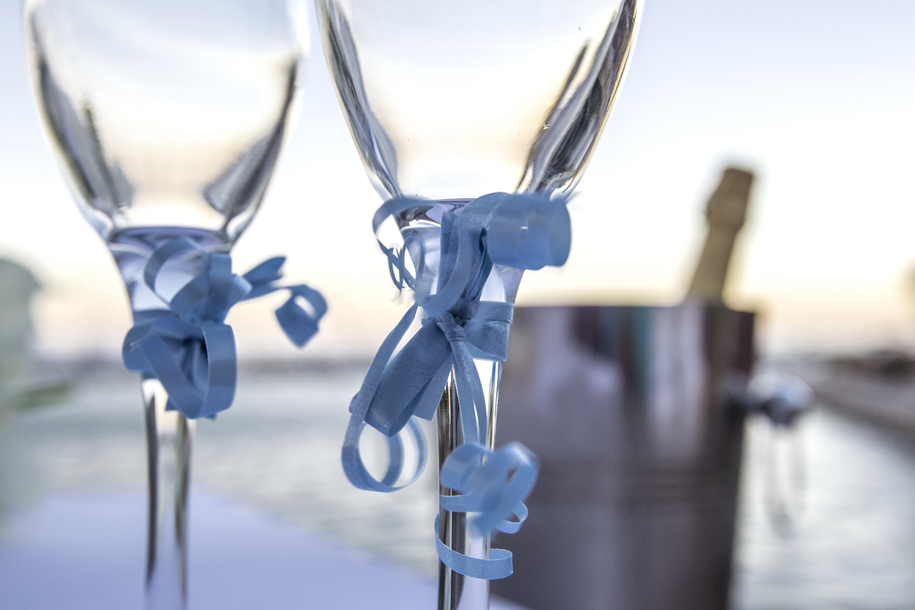 two glasses with blue ribbons