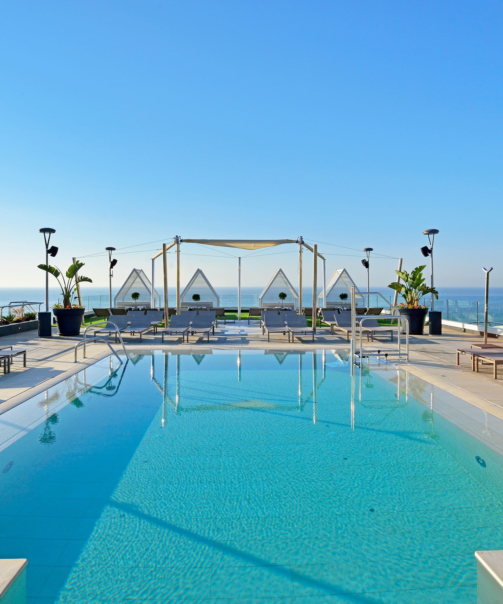 a swimming pool with a deck chair and a roof top