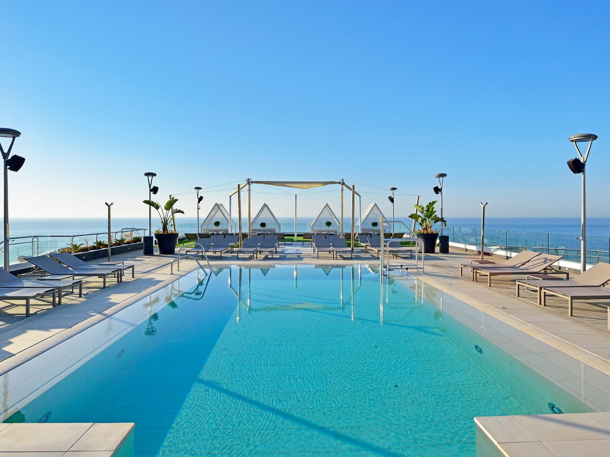 a swimming pool with a deck chair and a roof top