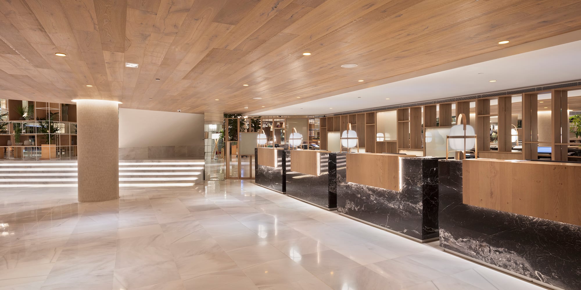 a lobby with marble flooring and a wood ceiling