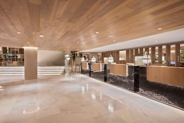 a lobby with marble flooring and a wood ceiling
