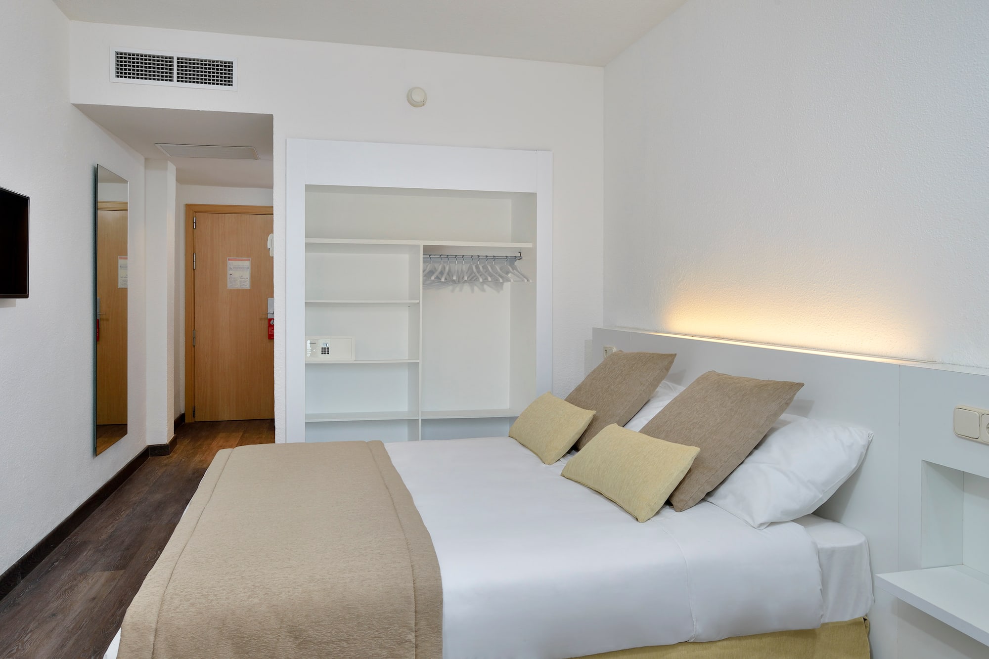 a bed with pillows in a room