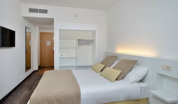 a bed with pillows in a room