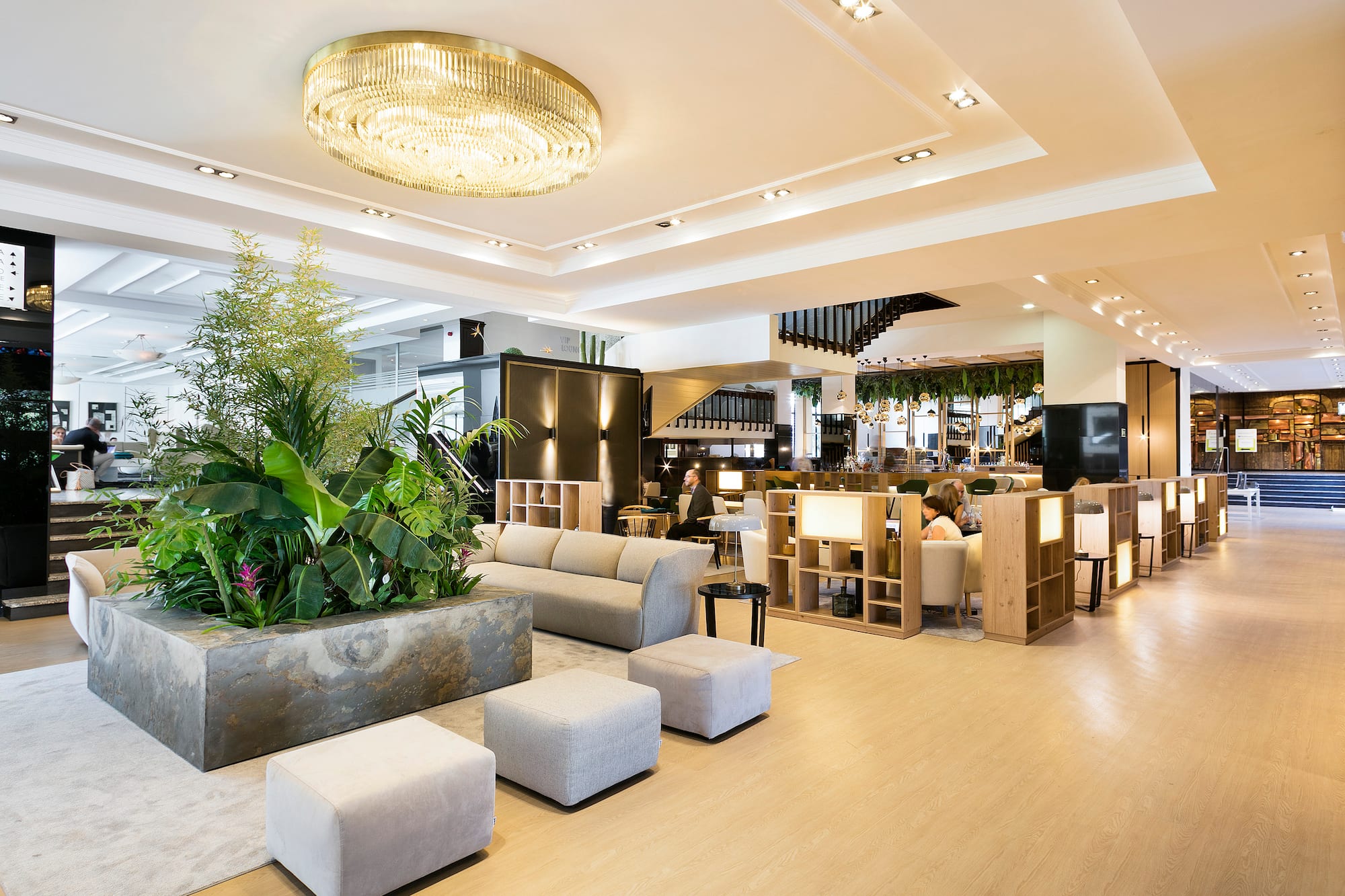a room with a large planter and a large chandelier
