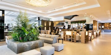 a room with a large planter and a large chandelier