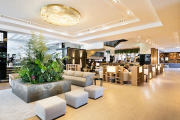 a room with a large planter and a large chandelier