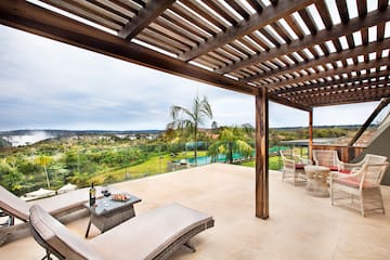 a patio with a view of a pool and a table