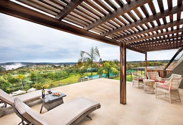 a patio with a view of a pool and a table