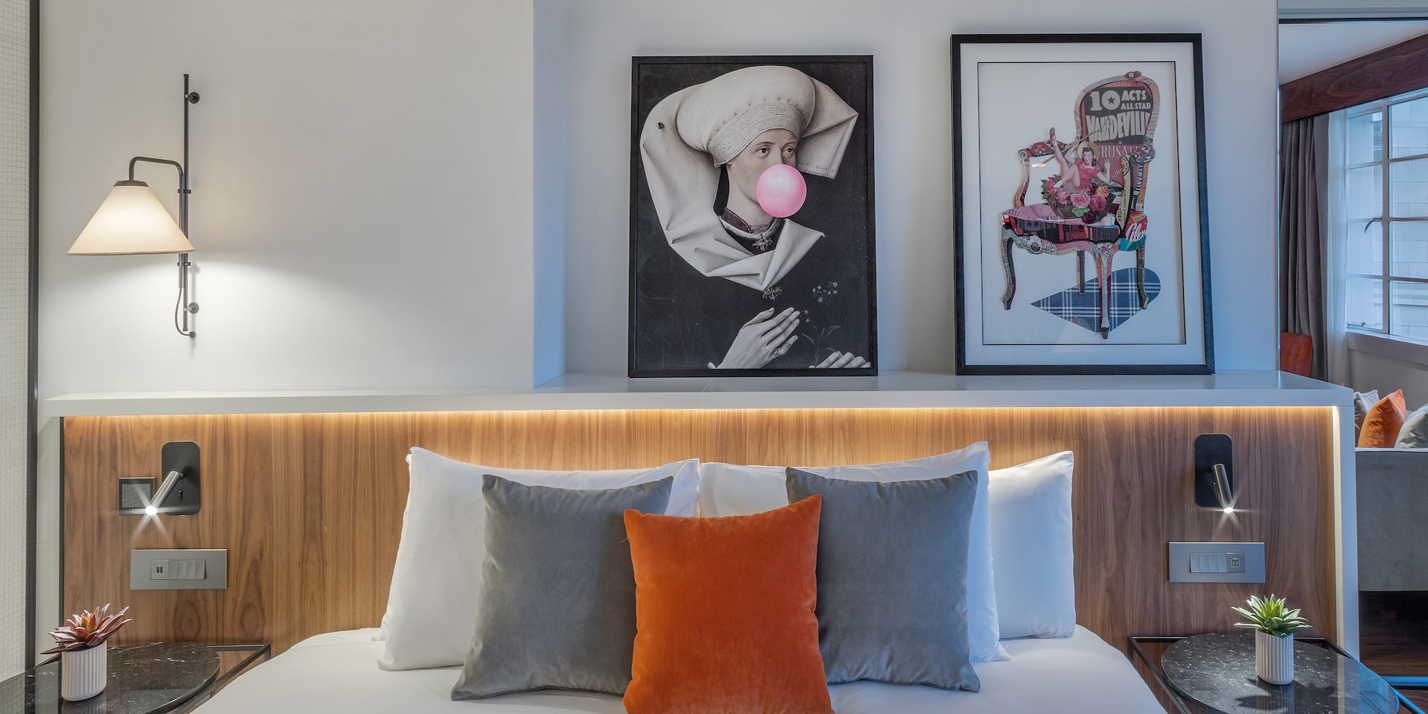 a bed with pillows and a lamp