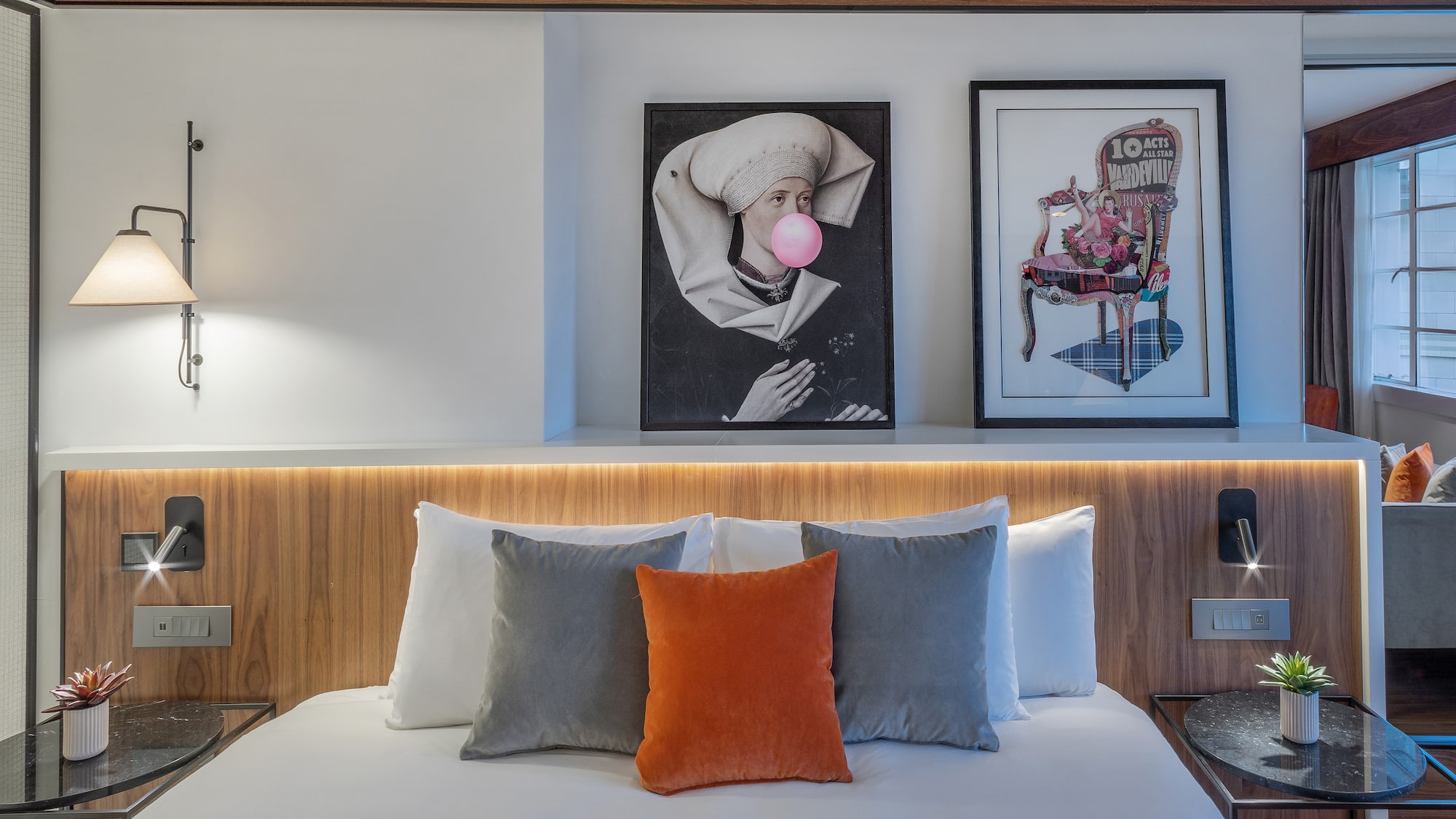 a bed with pillows and a lamp