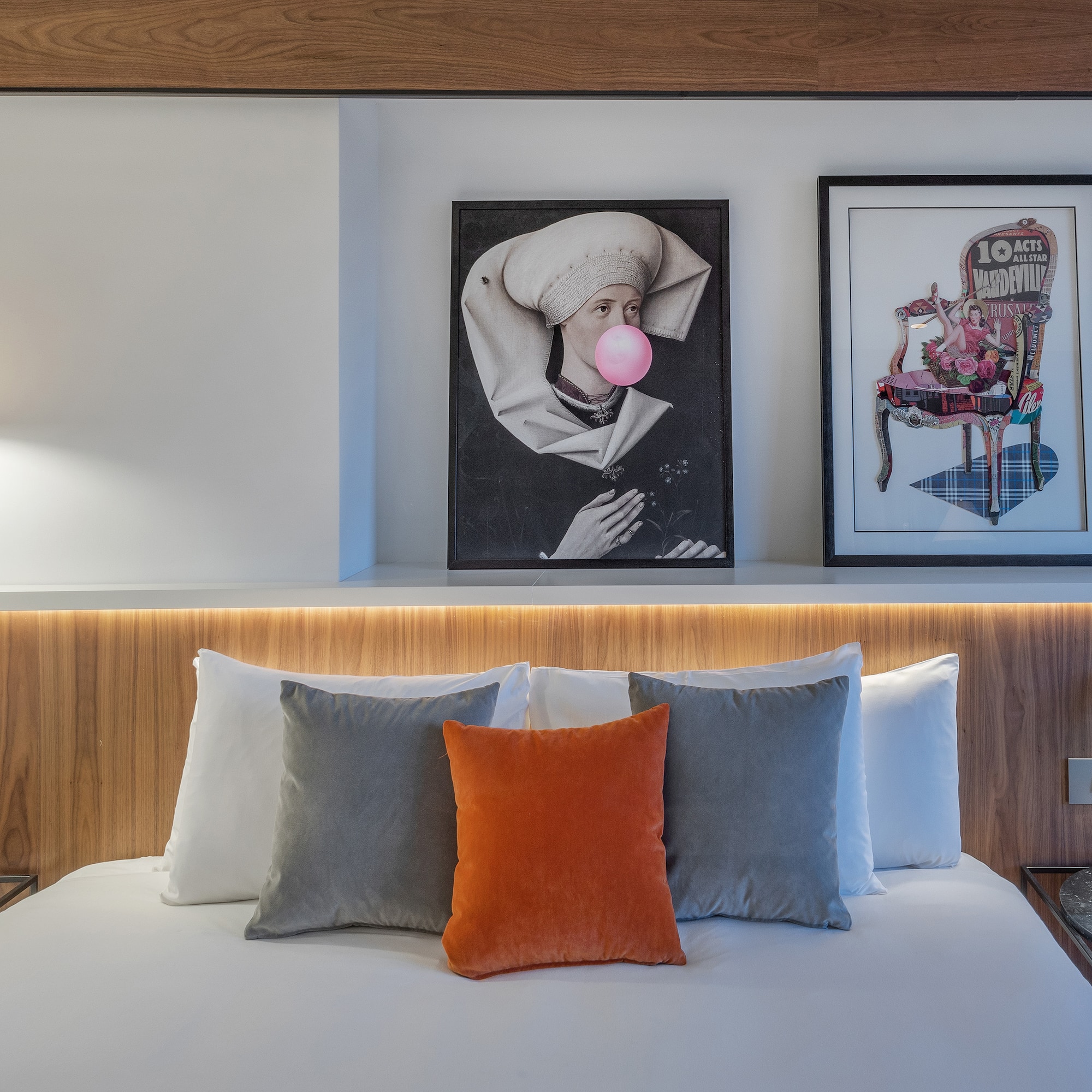 a bed with pillows and a lamp