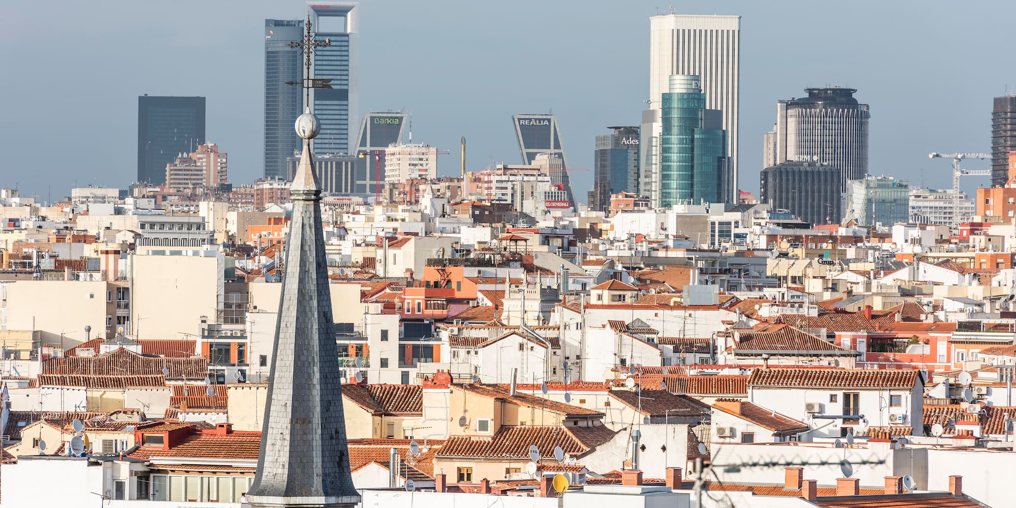 a city with a steeple and a city skyline