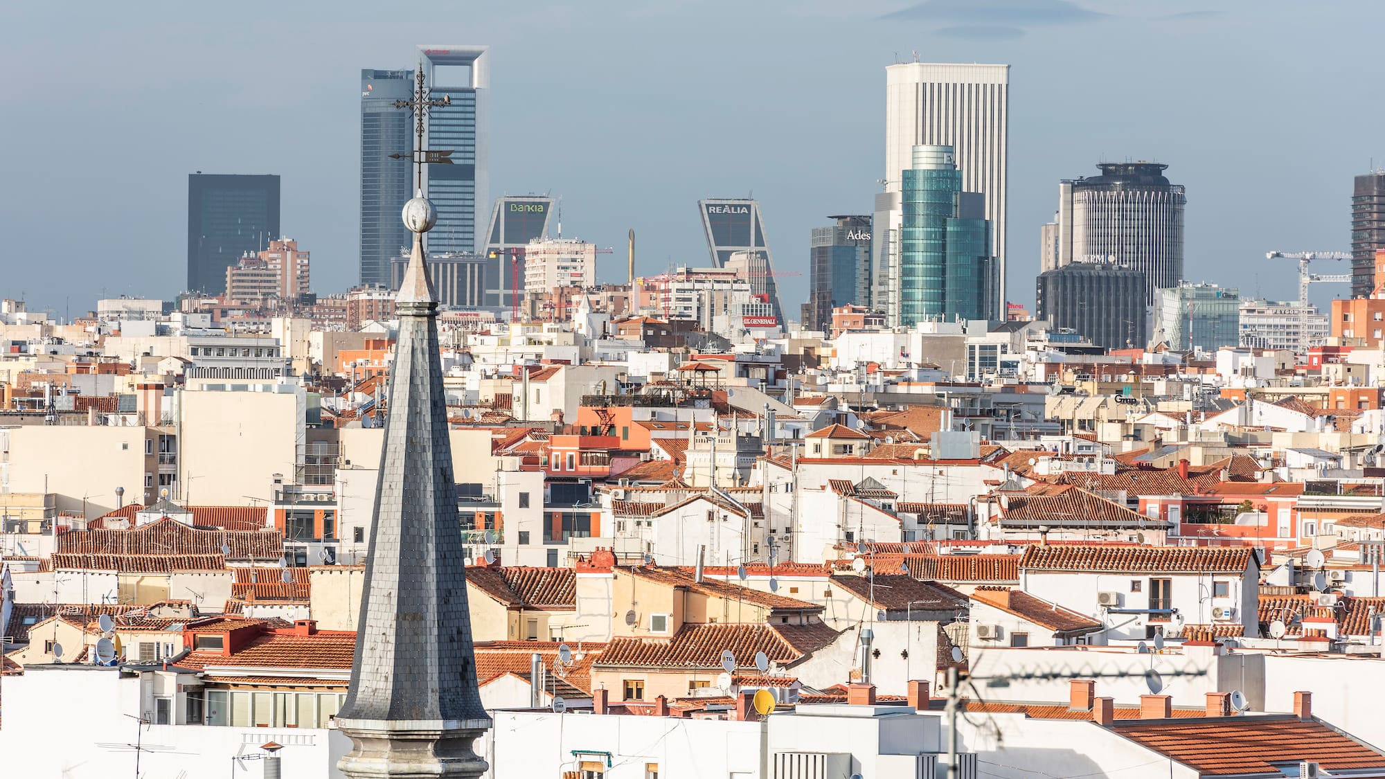 a city with a steeple and a city skyline