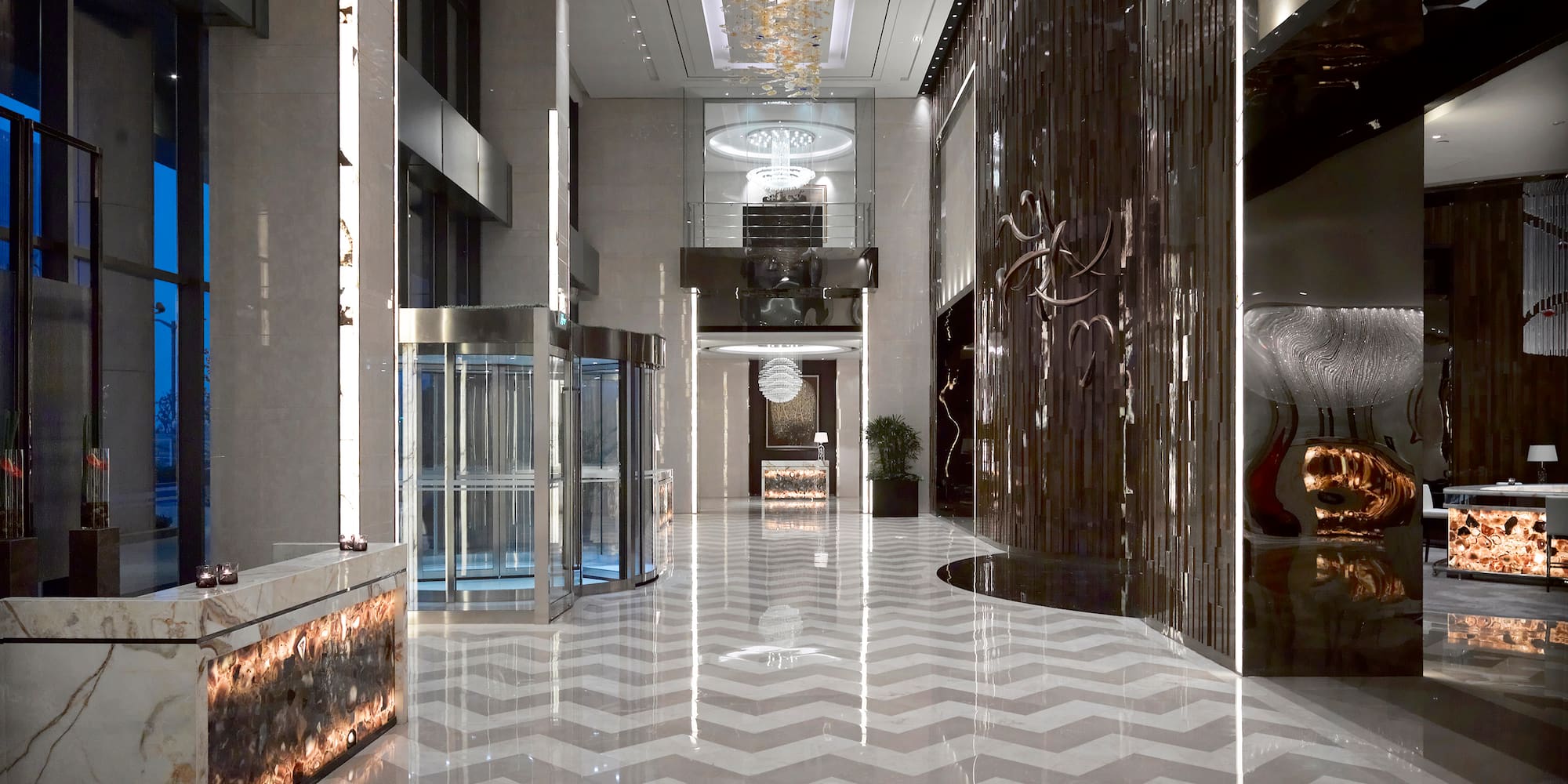 a large hall with glass doors and a chevron floor