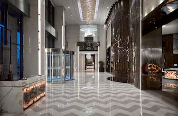 a large hall with glass doors and a chevron floor