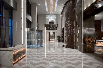 a large hall with glass doors and a chevron floor