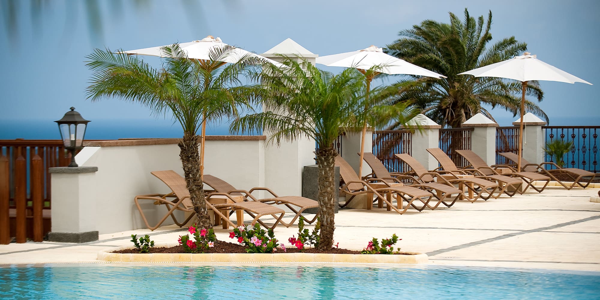 a pool with lounge chairs and umbrellas