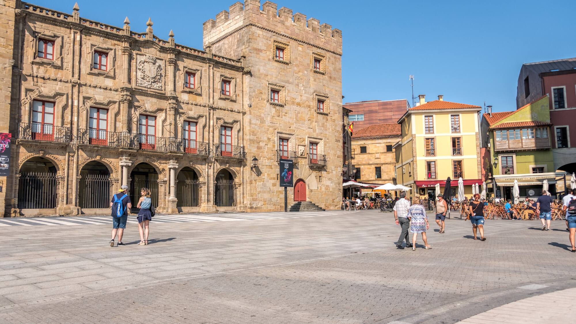 a group of people walking in a plaza