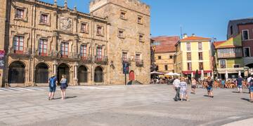 a group of people walking in a plaza